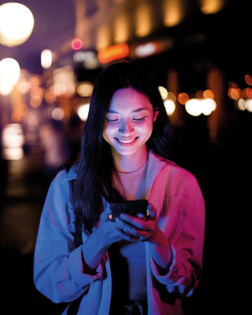 Person on smartphone with dark pink light