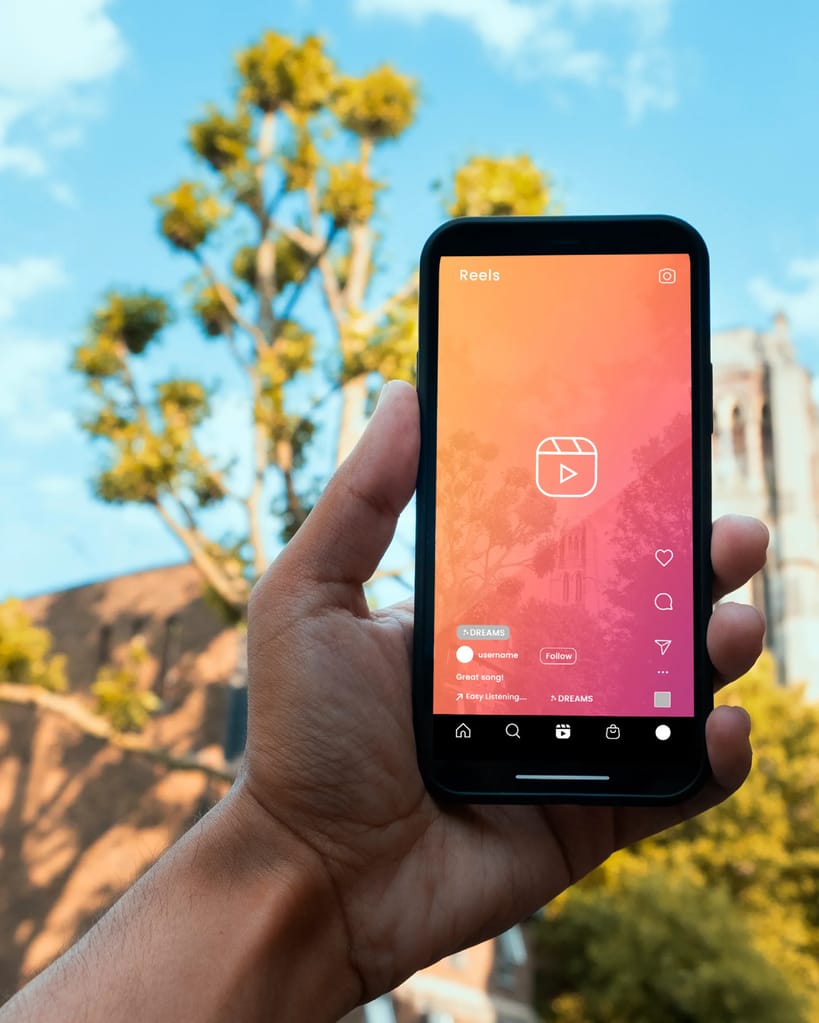 Smartphone with Instagram-Reel showcase in front of outside background