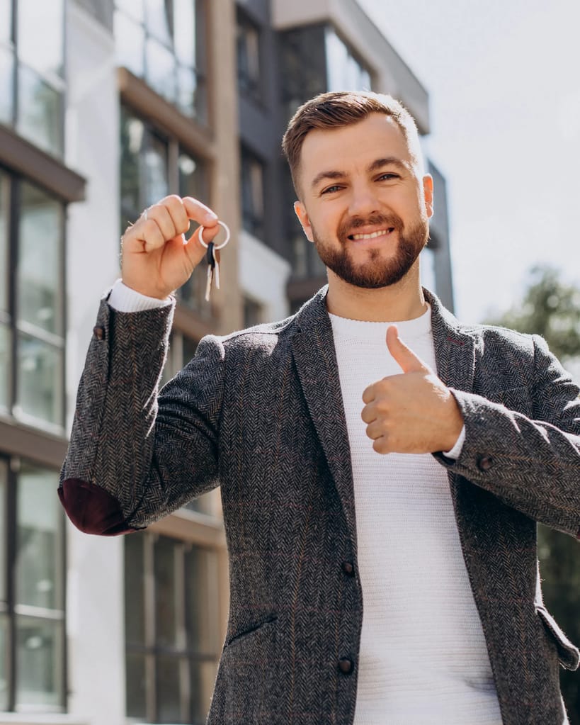 Young man with keys just bought new appartment